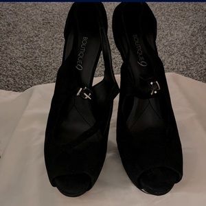 Black peep toe platform pump with silver heel. Size US 8